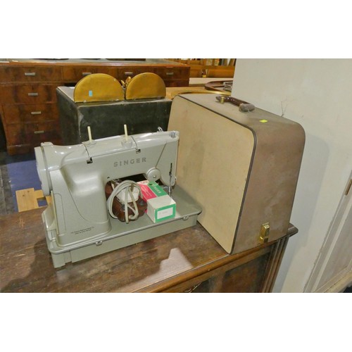 A vintage Singer electric sewing machine with carry case