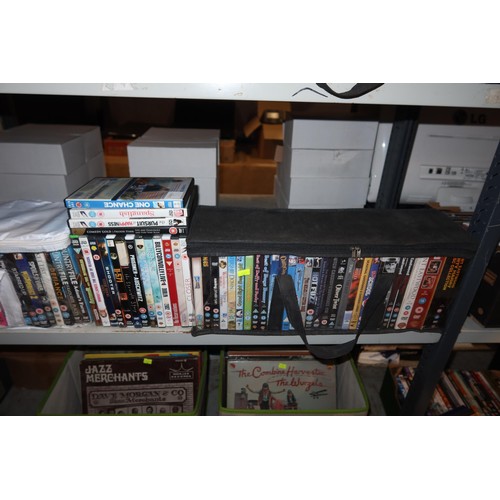 2438 - A large quantity of various DVDs, contents of 2 shelves