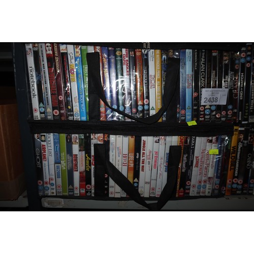 2438 - A large quantity of various DVDs, contents of 2 shelves