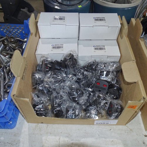 5089 - A box containing a quantity of UK to EU mains adapter plugs