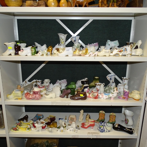 3076 - A large quantity of miscellaneous decorative vintage china shoes and boots (three shelves)