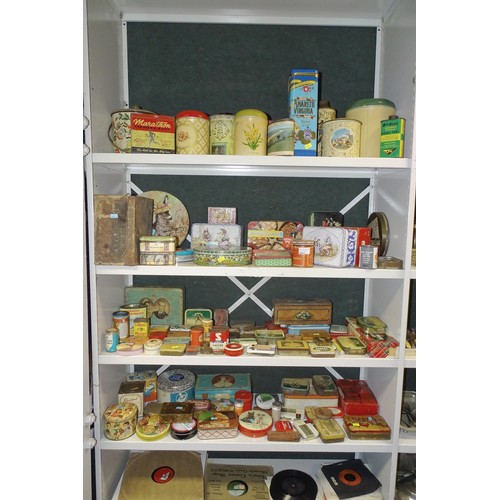 3081 - A large quantity of miscellaneous decorative vintage storage tins and advertising tins (four shelves... 