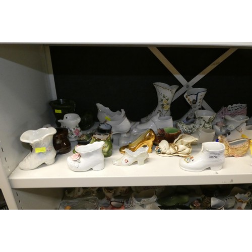 3076 - A large quantity of miscellaneous decorative vintage china shoes and boots (three shelves)