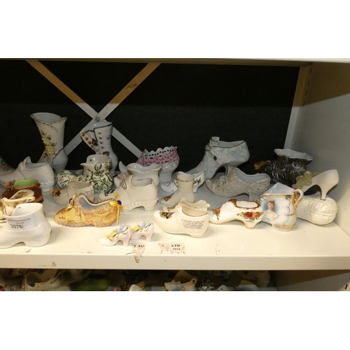 3076 - A large quantity of miscellaneous decorative vintage china shoes and boots (three shelves)