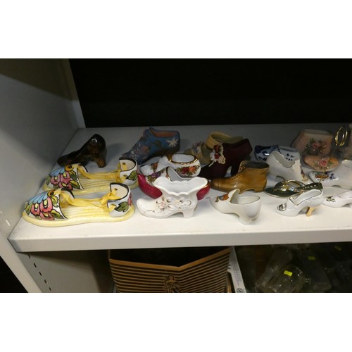 3076 - A large quantity of miscellaneous decorative vintage china shoes and boots (three shelves)