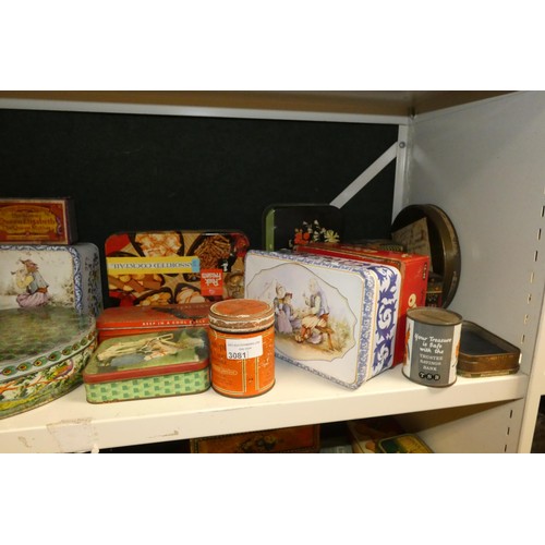 3081 - A large quantity of miscellaneous decorative vintage storage tins and advertising tins (four shelves... 