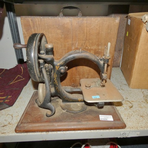 3109 - A vintage hand sewing machine with wooden carry case