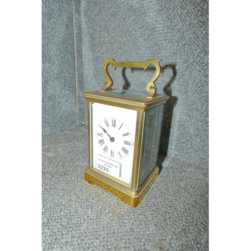3233 - A brass French carriage clock with Roman numerals