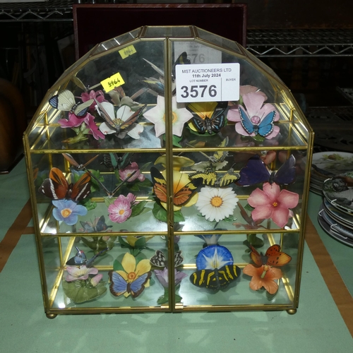 A small table top display cabinet containing a display of ceramic ...