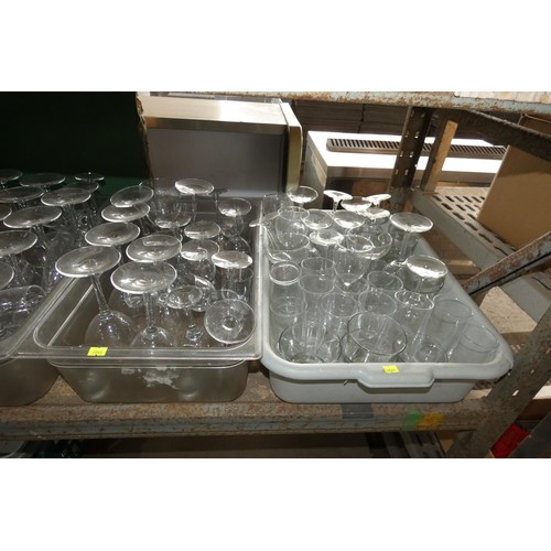 1023 - A quantity of various drinking glasses, contents of 1 wide shelf