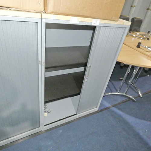 1402 - 1 x light grey metal tambour front storage cabinet with a wood effect top approx 47cm d x 80cm w x 1... 