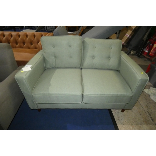 423 - A light green upholstered two person sofa approx 130cm wide