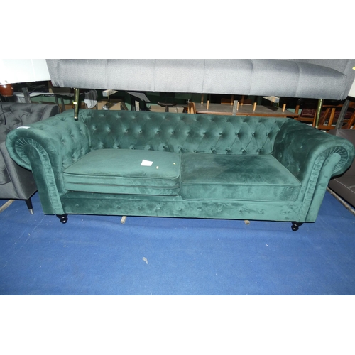 434 - A green upholstered Chesterfield style button back three person sofa approx 220cm wide