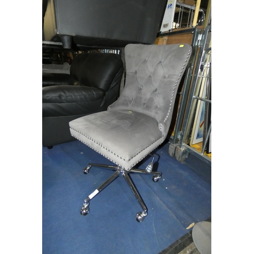 440 - A grey upholstered adjustable height swivel chair with button back and metal stud decoration