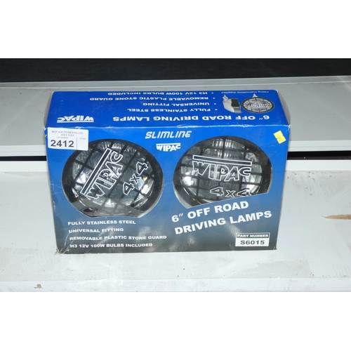 2412 - A boxed pair of 6 inch driving spot lights by Wipac type 4x4