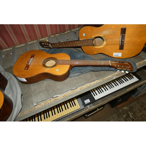 2519 - A small acoustic guitar with soft carry case, no make or model visible