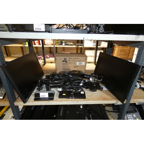 2589 - An office desk set-up including a laptop port replicator by HP, 2 x 22 inch Hannspree monitors and a... 