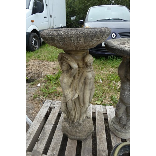 2389 - A weathered concrete bird bath on a classic style pedestal