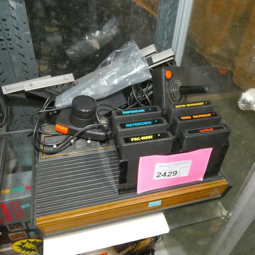 2429 - A vintage Atari video game console with 6 games and controllers, please see pictures for more detail... 