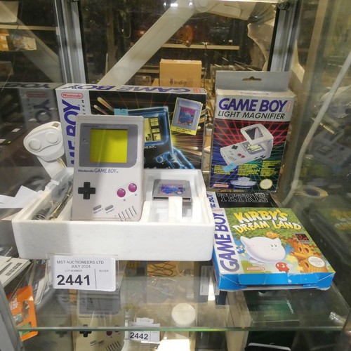 2441 - A vintage boxed handheld Gameboy game console by Nintendo with Tetris, Kirby's Dream Land and light ... 