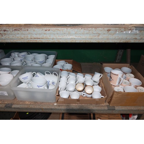 1053 - A quantity of various white crockery, cups and saucers, mugs and cups branded Patisserie Valerie