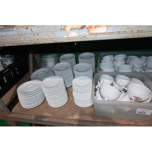 1053 - A quantity of various white crockery, cups and saucers, mugs and cups branded Patisserie Valerie