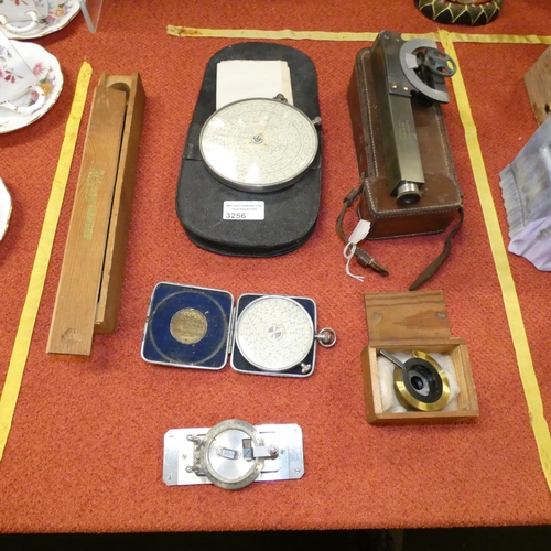 A vintage Greenough's prism rotator, a vintage precision level, 2 ...