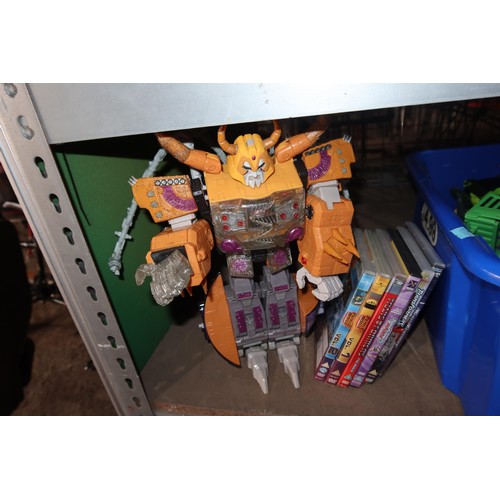 2102 - A quantity of various Transformer related items including toys, DVDs and a 3D 100 piece stand up puz... 