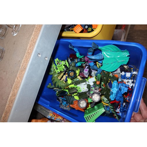 2102 - A quantity of various Transformer related items including toys, DVDs and a 3D 100 piece stand up puz... 