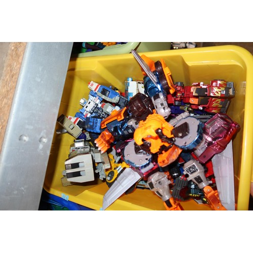 2102 - A quantity of various Transformer related items including toys, DVDs and a 3D 100 piece stand up puz... 