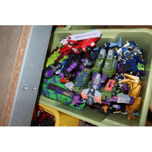 2102 - A quantity of various Transformer related items including toys, DVDs and a 3D 100 piece stand up puz... 