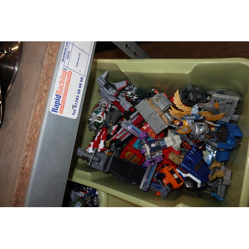 2102 - A quantity of various Transformer related items including toys, DVDs and a 3D 100 piece stand up puz... 