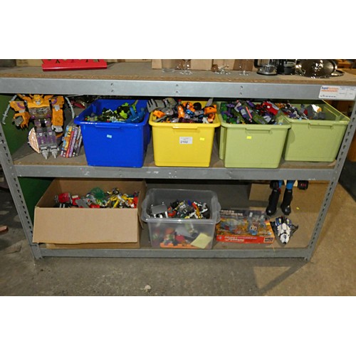 2102 - A quantity of various Transformer related items including toys, DVDs and a 3D 100 piece stand up puz... 