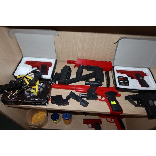 2254 - A quantity of various Air Soft BB guns, a target and an Armex Black Shadow catapult. Contents of 3 s... 