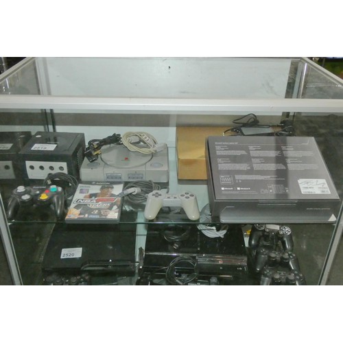 2519 - A Nintendo GameCube console with controller, no leads and a Sony Playstation 1 original console with... 