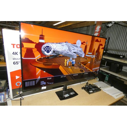 2525 - A 65 inch 4K UHD Smart TV by Toshiba type 65UL2163DBC comes with universal stand and remote - trade ... 