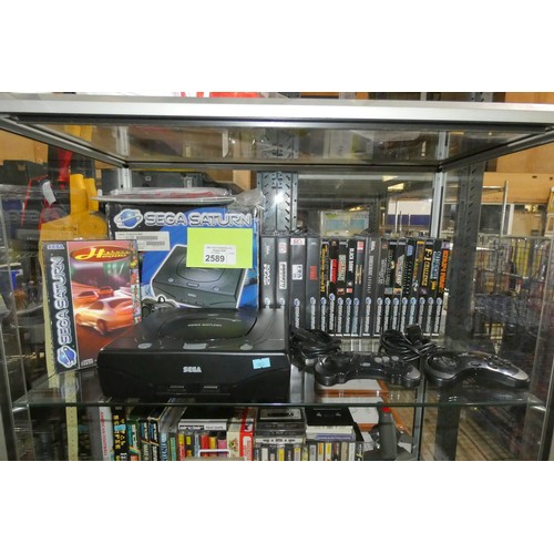 2589 - A Sega Saturn video game console with box, 2 controllers and 19 boxed games including Highway 2000, ... 