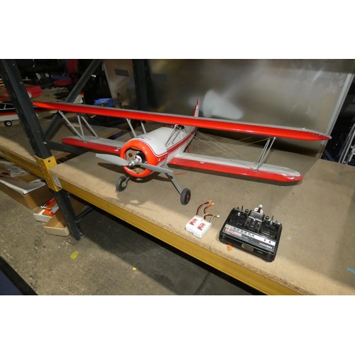 2679 - A red / white radio controlled model biplane aircraft (no make visible) fitted with 1 x electric mot... 