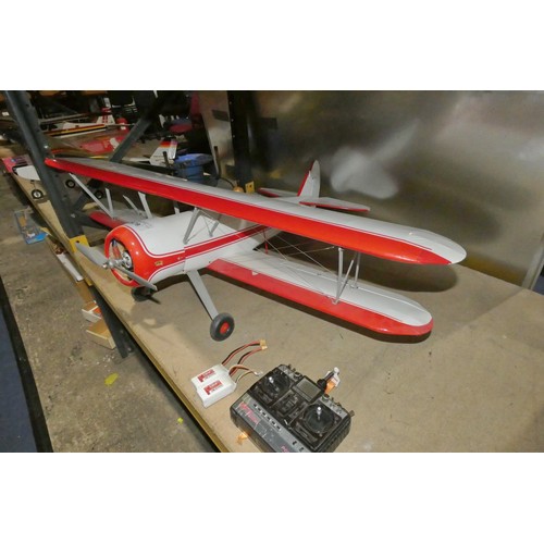 2679 - A red / white radio controlled model biplane aircraft (no make visible) fitted with 1 x electric mot... 