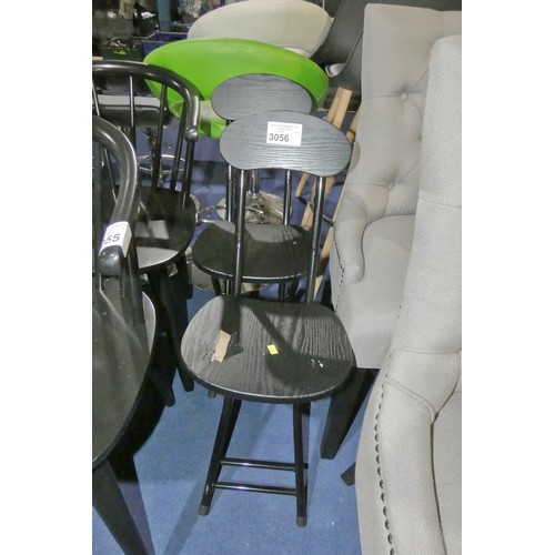 3056 - 2 x small black folding chairs. Please note that one chair has lost the black finish on the seat pad