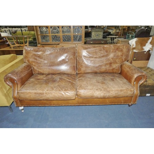 3070 - 1 x brown leather upholstered three person sofa approx 200cm wide. Please note that this sofa is use... 