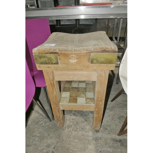 2243 - A vintage wooden chopping block on a wooden stand