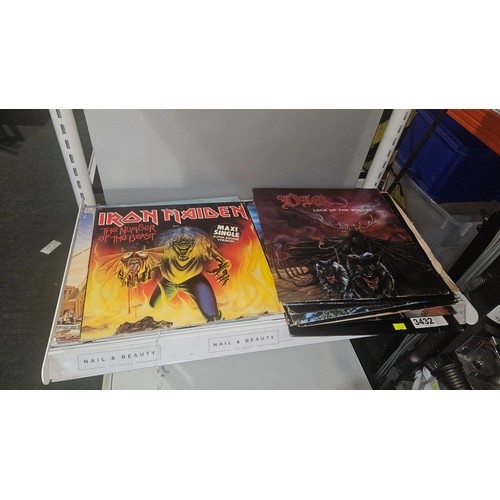 3432 - A quantity of various heavy metal 45rpm & 33rpm records including ACDC, Iron Maiden, Wasp, Guns and ... 