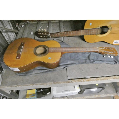 3411 - A small acoustic guitar with soft carry case, no make or model visible