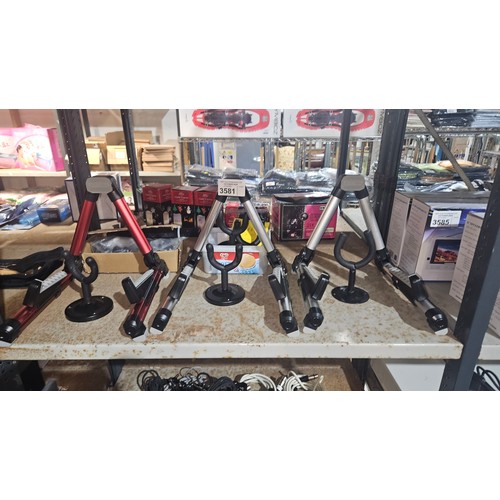 3581 - 3 x guitar stands by Aroma with other spare guitar related parts, contents of 1 shelf