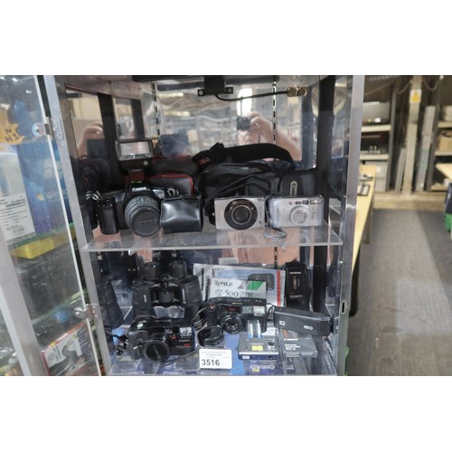 3516 - A quantity of various cameras, 35mm, digital, including a Canon EOS 1000, Ixus Z70 etc, a Dictaphone... 