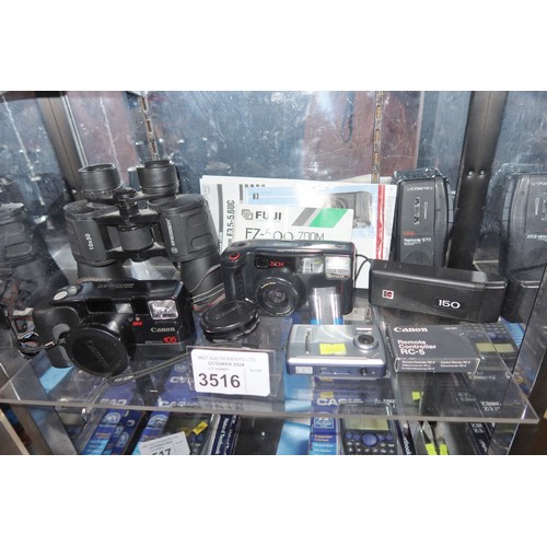 3516 - A quantity of various cameras, 35mm, digital, including a Canon EOS 1000, Ixus Z70 etc, a Dictaphone... 