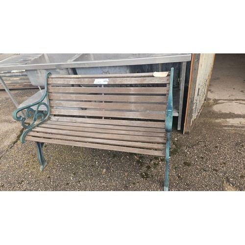 3691 - A 3 person garden bench with decorative metal ends