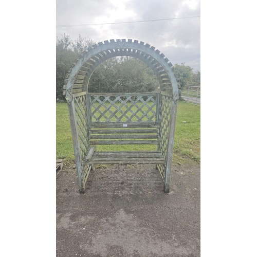 3667 - A garden bench/love seat under an arched trellis