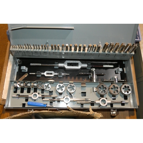 5100 - A grey metal carry case containing a metric tap and die set